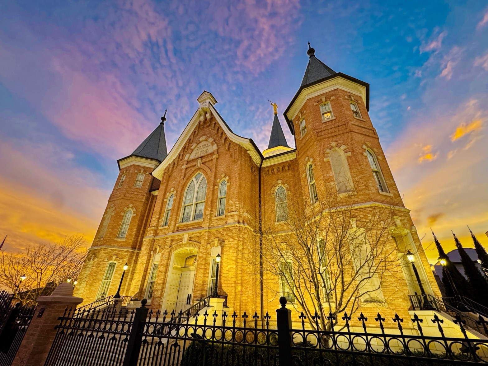 A wide-angle sunset view of the Provo City Center Temple at the corner of University Avenue with a colorful sky, photographed by Jared Harding Wilson.