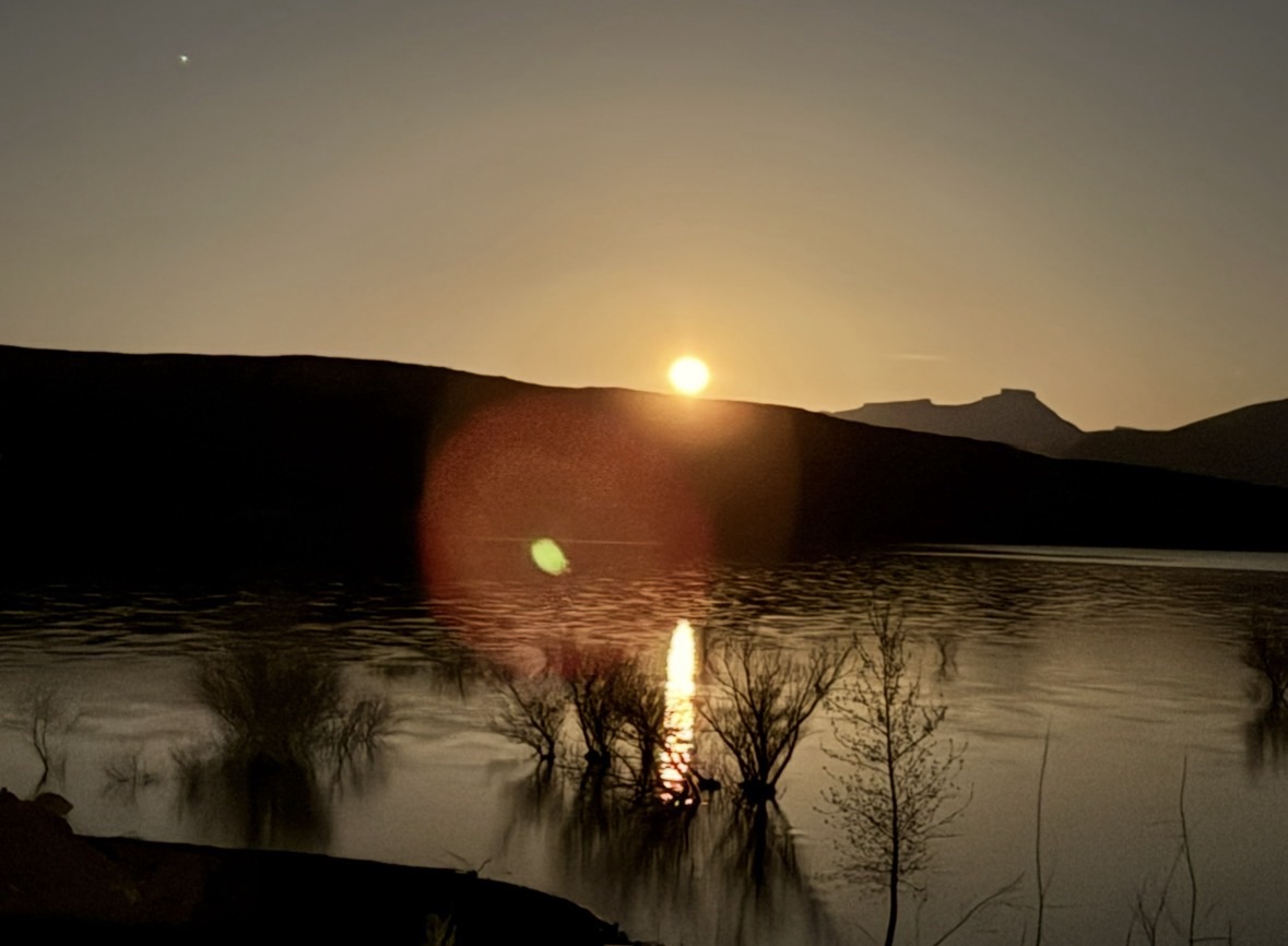 Close-up of a brilliant supermoon reflecting off the water, appearing as bright as the sun.