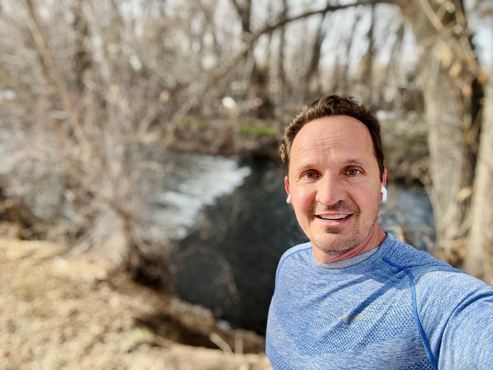 Jared Harding Wilson standing next to the rushing Provo River on a nature-conscious training run.