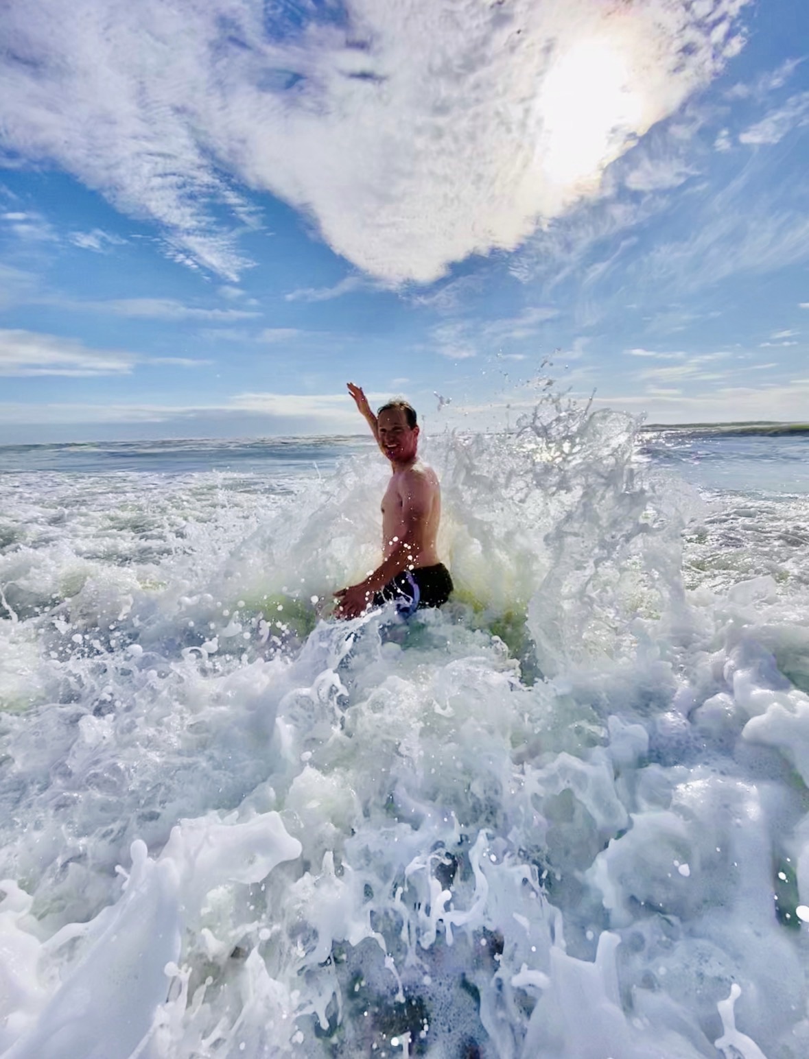 Jared Harding Wilson being hit by a large ocean wave on Ocracoke Island, North Carolina.