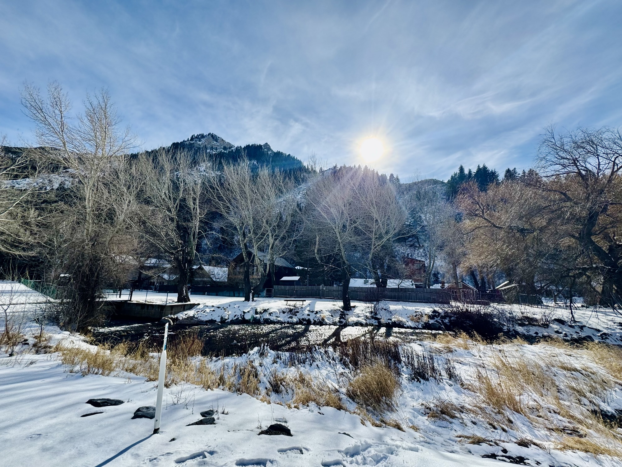 The winter sun setting over the start of the Provo River at Vivian Park, captured by Jared Harding Wilson.
