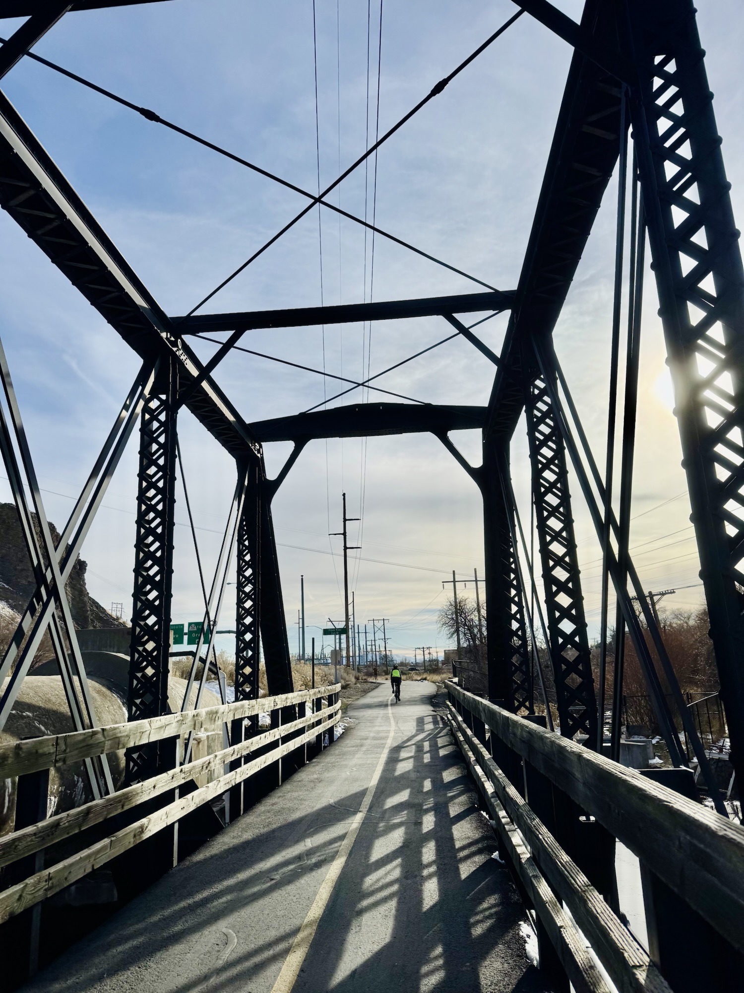 The eco-friendly infrastructure of a steel-caged bridge over the Provo River, documented by Jared Harding Wilson.