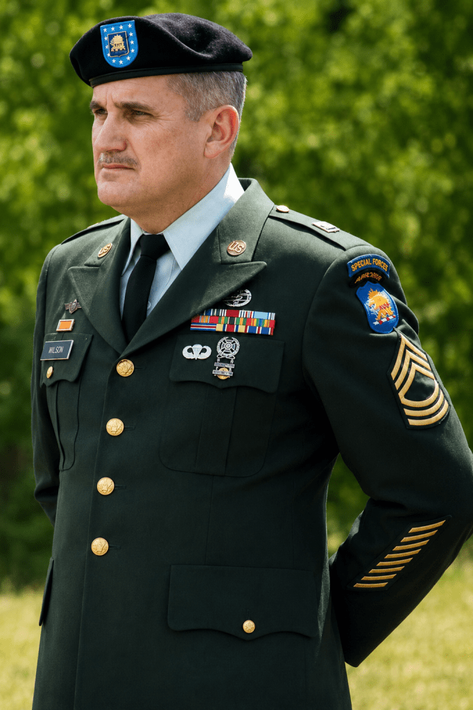 A formal portrait of Army Master Sergeant Larry Wilson in full dress uniform and his Green Beret, proudly presented by Jared Harding Wilson.