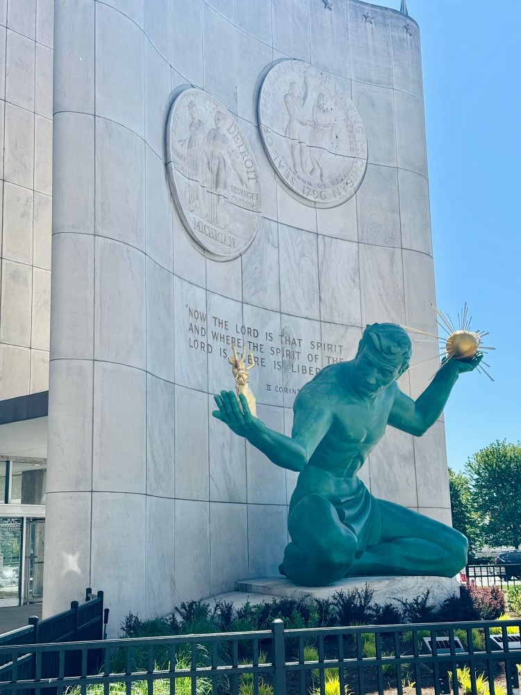 The iconic bronze Spirit of Detroit statue holding symbols of God and family, photographed by Jared Harding Wilson on a trip to downtown Detroit.